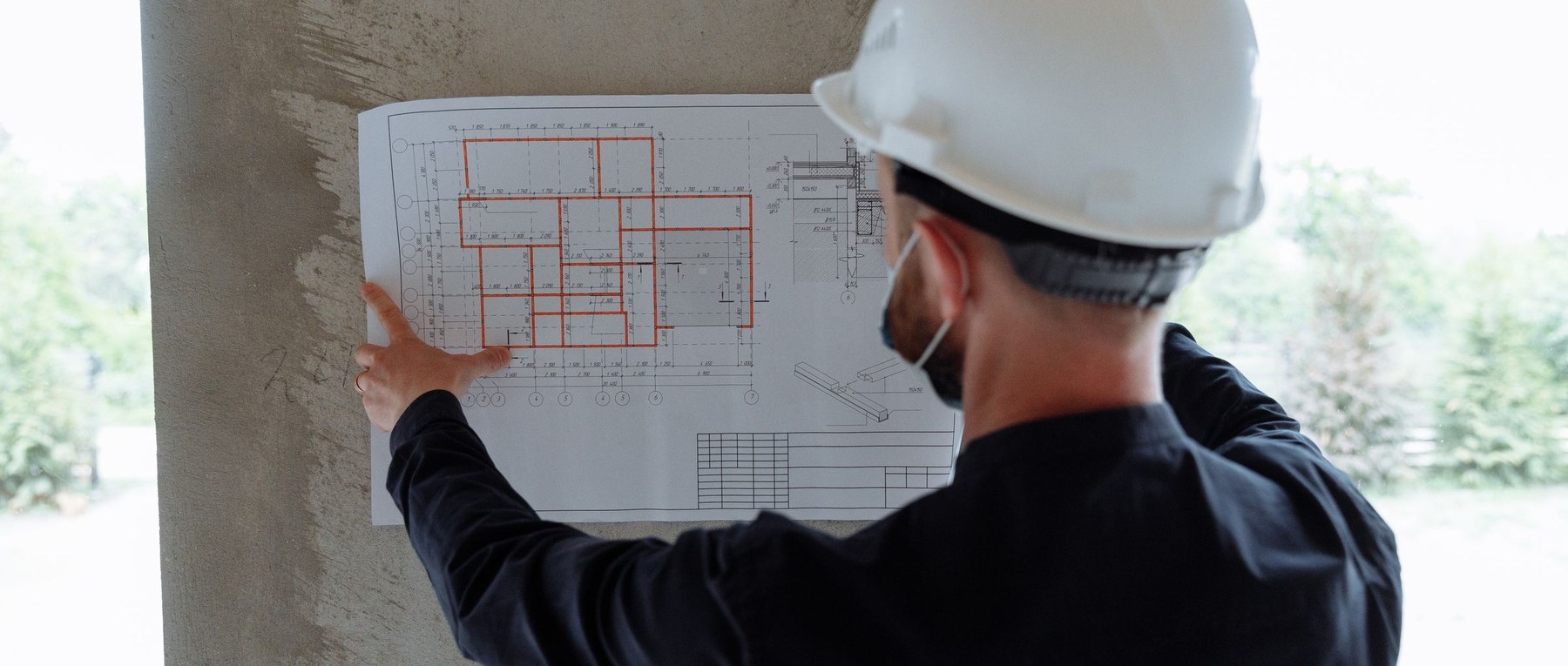 Site engineer reviewing building plans on-site