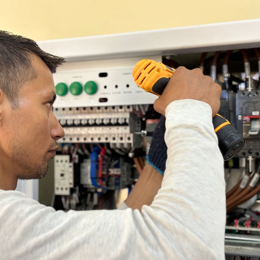 Electrician working on a distribution panel