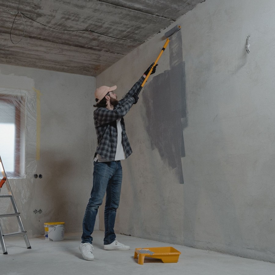Painter applying interior wall paint